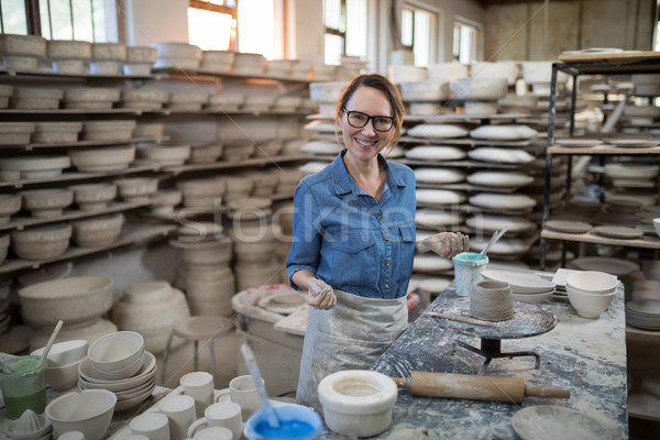 Portrait of female potter molding a clay Stock photo © wavebreak_media