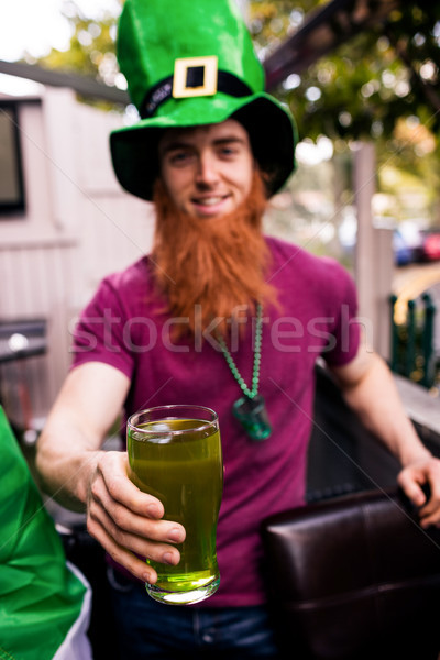 Stock photo: Disguised man holding a green pint 