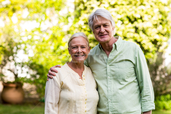 Stock photo: Smiling senior couple in yard