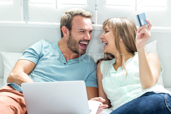 Couple utilisant un ordinateur portable lit maison heureux ordinateur [[stock_photo]] © wavebreak_media