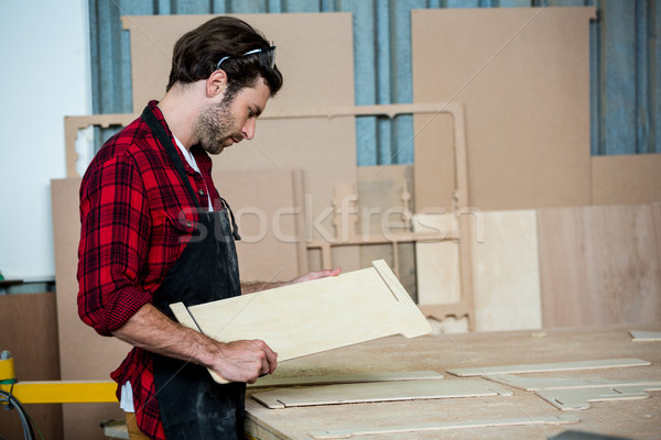 Stock photo: Carpenter working on his craft 