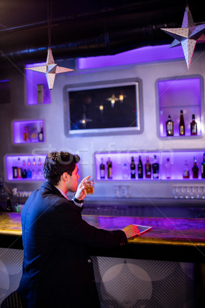 Man Having Beer At Bar Counter Stock Photo Wavebreak Media Ltd Man Having Beer At Bar Counter Stock