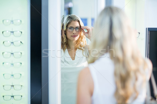Beautiful female customer trying spectacles Stock photo © wavebreak_media