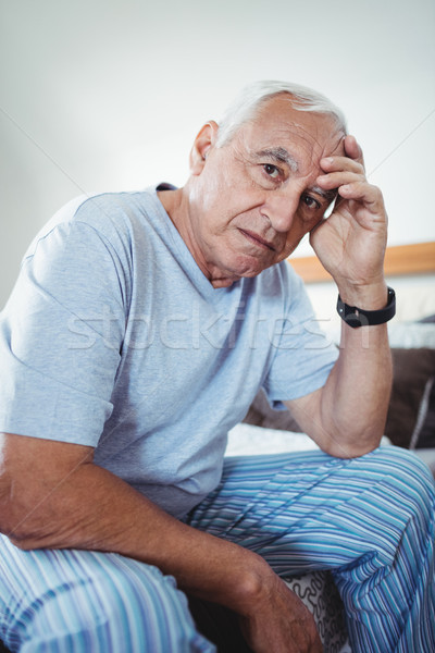 Stock photo: Frustrated senior man sitting on bed