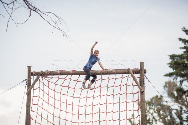 Fit woman with hand raised celebrating success during obstacle course Stock photo © wavebreak_media