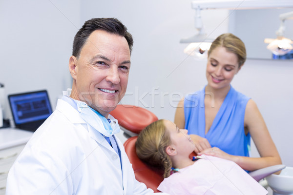 Dentist smiling at camera in dental clinic Stock photo © wavebreak_media