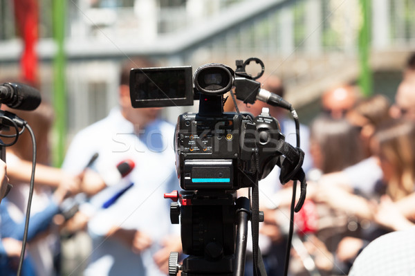 Press or news conference. Filming media event with a video camer Stock photo © wellphoto