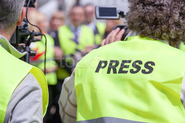 Stock photo: Shooting an event with a video camera. Press conference.