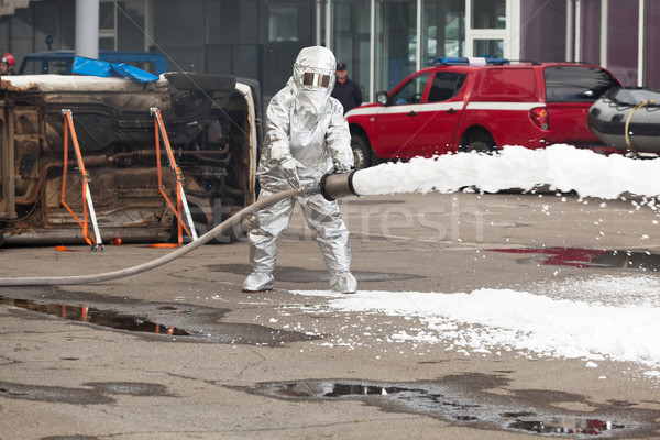 Firemen spray firefighting foam Stock photo © wellphoto