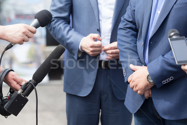 Journalists holding microphones conducting media interview. News Stock photo © wellphoto