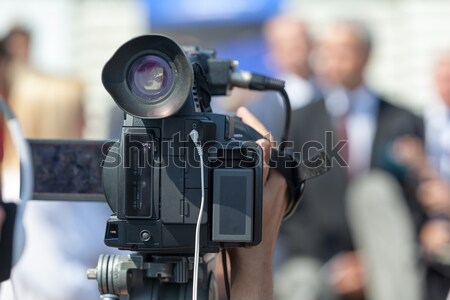 News conference. Filming an event with a video camera. Stock photo © wellphoto