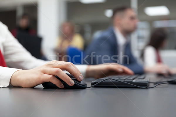 Close up of female hand on mouse while typing on keyboard Stock photo © wellphoto