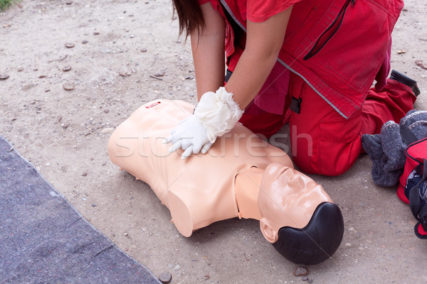 Female paramedic showing cardiopulmonary resuscitation - CPR on training doll. Stock photo © wellphoto