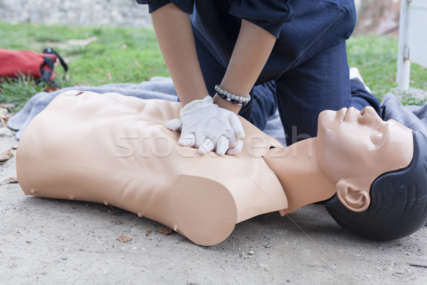 Paramedic demonstrates CPR on a dummy Stock photo © wellphoto