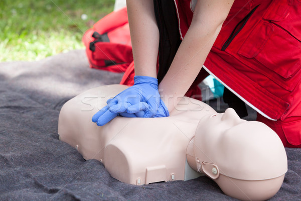 Paramedic demonstrate Cardiopulmonary resuscitation (CPR) on dummy Stock photo © wellphoto