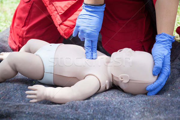 Baby CPR dummy first aid training. Heart massage. Stock photo © wellphoto