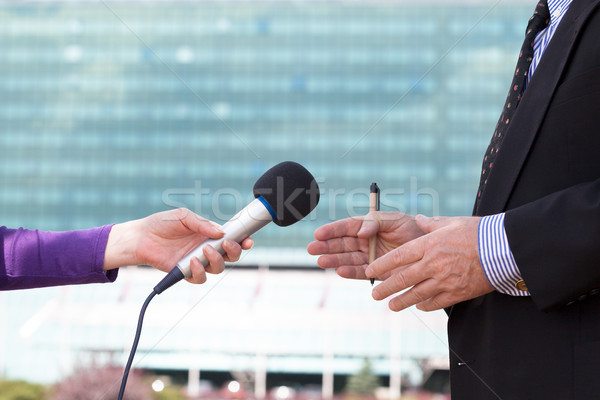 Journalist interviewing businessperson, corporate building in ba Stock photo © wellphoto