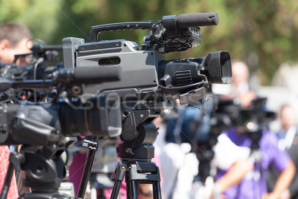 Press conference. Television camera in focus against blurred bac Stock photo © wellphoto
