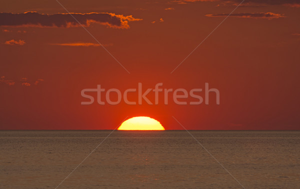 Sun Setting into the Ocean Stock photo © wildnerdpix