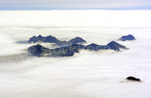 Aerial View of an Island Poking Through Ocean Fog Stock photo © wildnerdpix