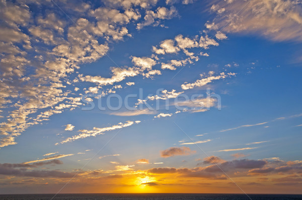 Orange and White Clouds in a Sunset over the Ocean Stock photo © wildnerdpix