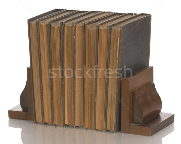 old books held up with wooden bookends with reflection on white background  Stock photo © willeecole