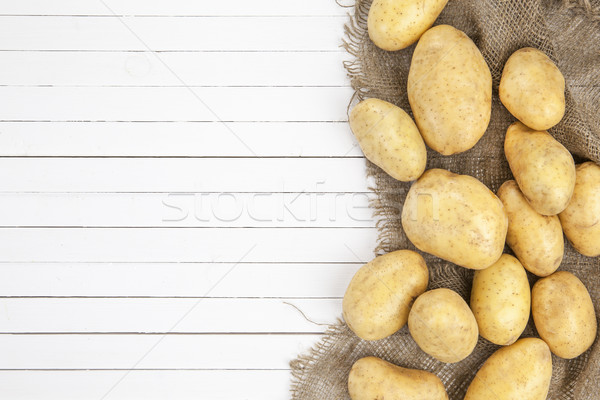 Potatoes on white wooden background, top view Stock photo © xamtiw