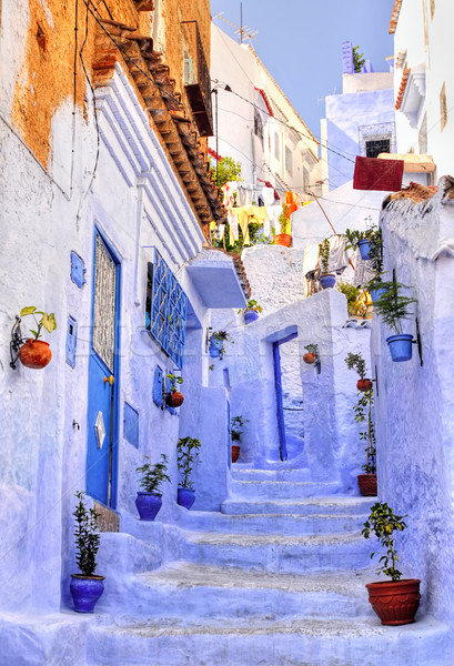 Street with stairs in medina of moroccan blue town Chaouen Stock photo © Xantana