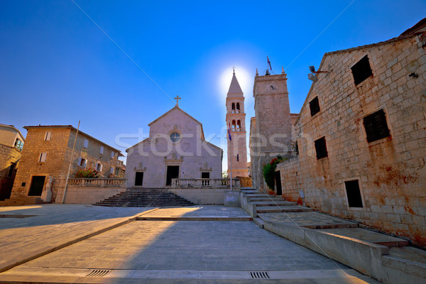 Square and church view in Supetar at sunset Stock photo © xbrchx