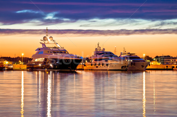 Luxury yachts harbor at golden hour view Stock photo © xbrchx