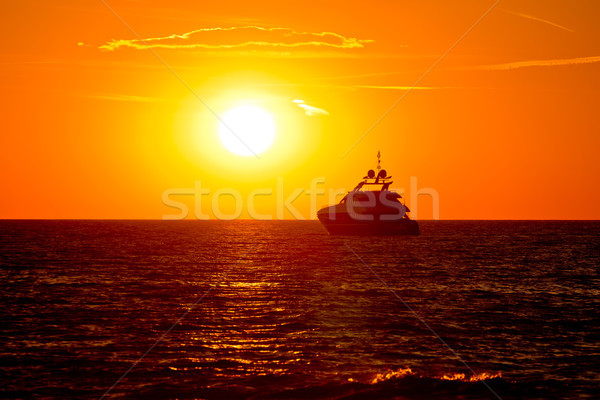 Luxury yacht on open sea at golden sunset Stock photo © xbrchx