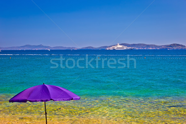 Adriatic beach in Zadar with megayacht background Stock photo © xbrchx