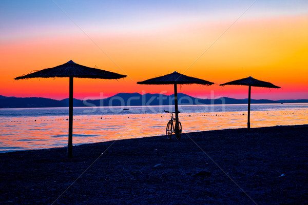 Beach and parasols on colorful sunset view Stock photo © xbrchx