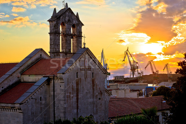 Town of Pula stone church and shipyard cranes sunset view Stock photo © xbrchx