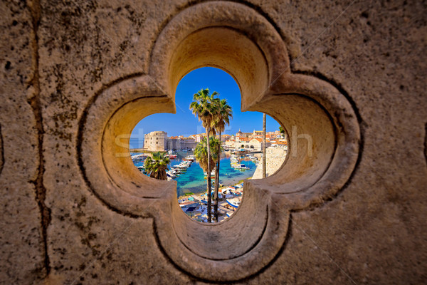 Dubrovnik harbor view from Ploce gate through stone carved detai Stock photo © xbrchx