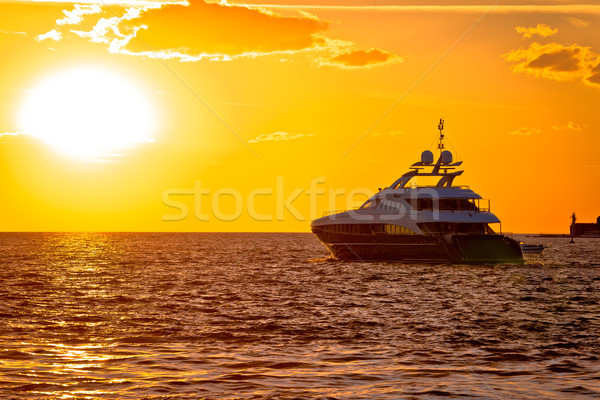Luxury yacht on open sea at golden sunset Stock photo © xbrchx