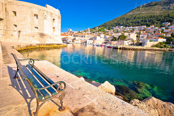 Dubrovnik harbor and city defense walls view from bench Stock photo © xbrchx
