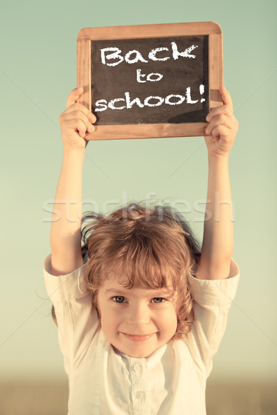 Schoolchild holding small blackboard Stock photo © Yaruta