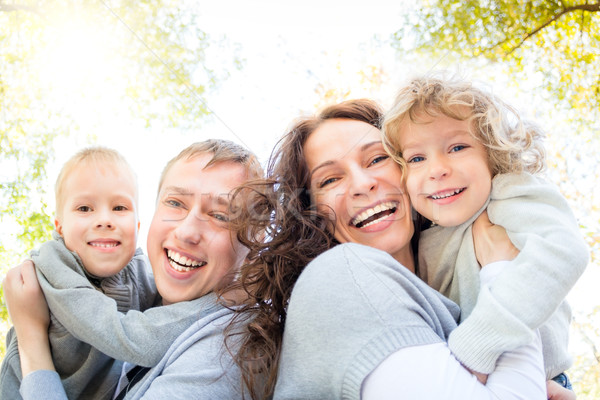 Happy family in autumn park Stock photo © Yaruta