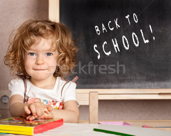 Smiling schoolchild in a class Stock photo © Yaruta