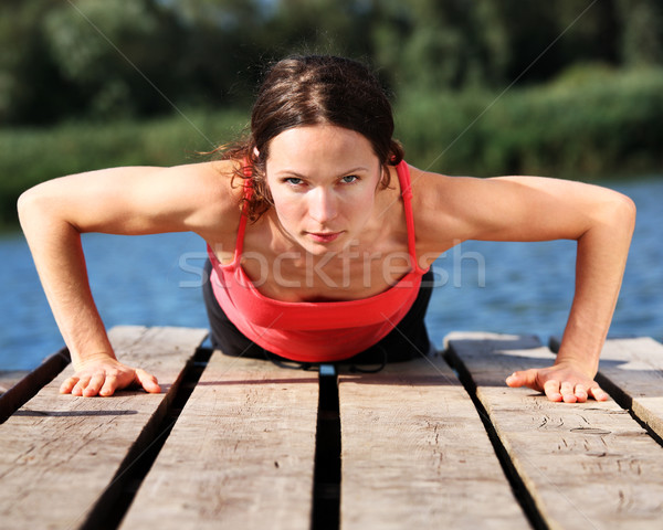 Woman doing push-ups Stock photo © Yaruta