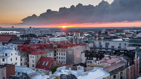 Helsinki rooftops at Sunset with dark clouds Stock photo © yhelfman