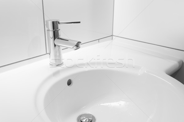 Faucet and white basin in a bathroom Stock photo © ymgerman