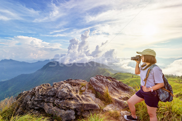 Hiker teen girl holding a camera for photography Stock photo © Yongkiet
