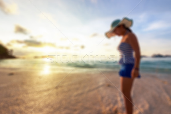 Blurred image woman on the beach at sunrise Stock photo © Yongkiet