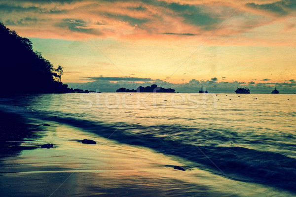 Vintage stylized photo of sunrise on the beach Stock photo © Yongkiet