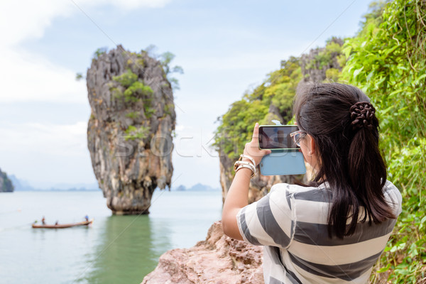 Women tourist shooting natural view by mobile phone Stock photo © Yongkiet