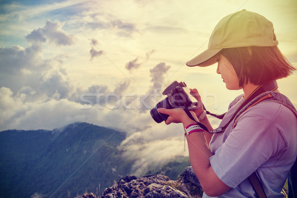 Vintage style hiker looking photo on camera Stock photo © Yongkiet