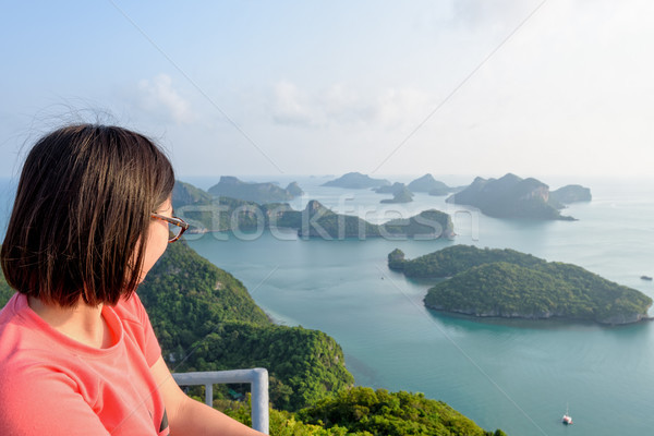 Woman on peak looking beautiful nature Stock photo © Yongkiet
