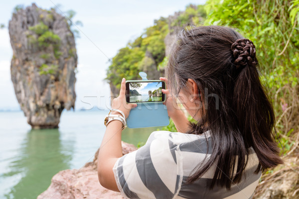 Women tourist shooting natural view by mobile phone Stock photo © Yongkiet